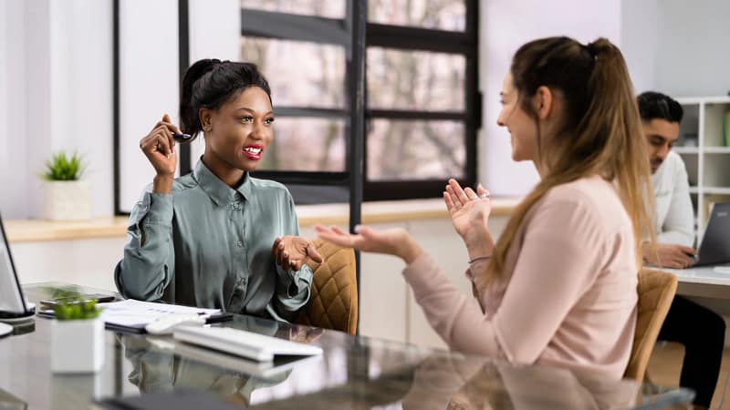 Leader overwhelmed by employees' requests, illustrating the hidden cost of solving everyone else's problems.
